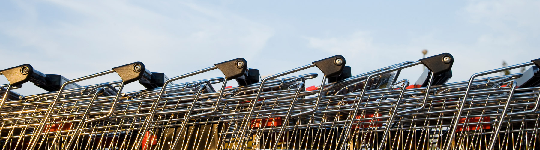 Line of grocery carts outside in parking lot