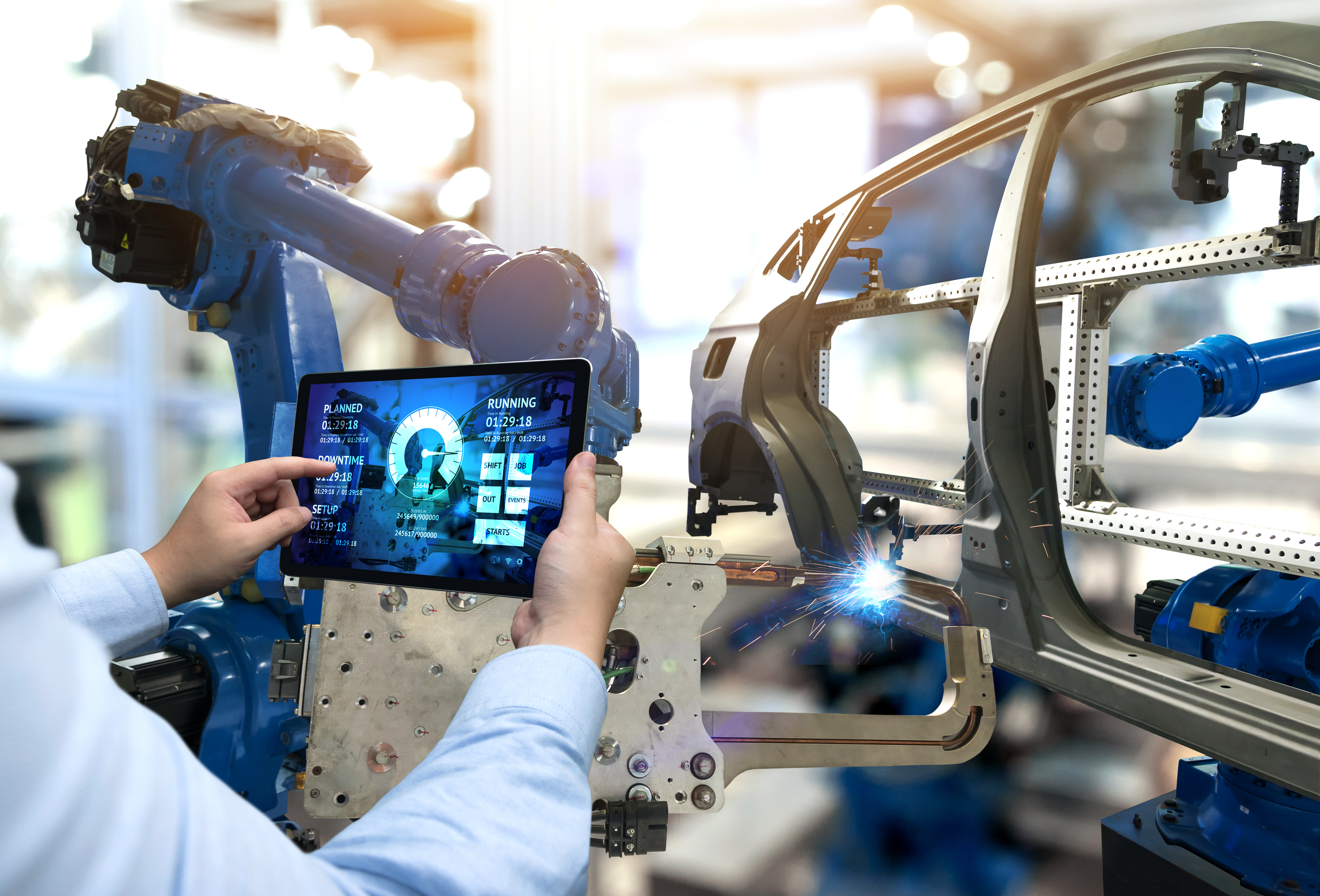 Engineer hand using tablet with machine real time monitoring system software